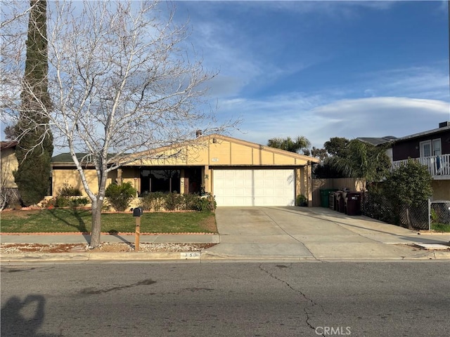 ranch-style home with an attached garage and driveway