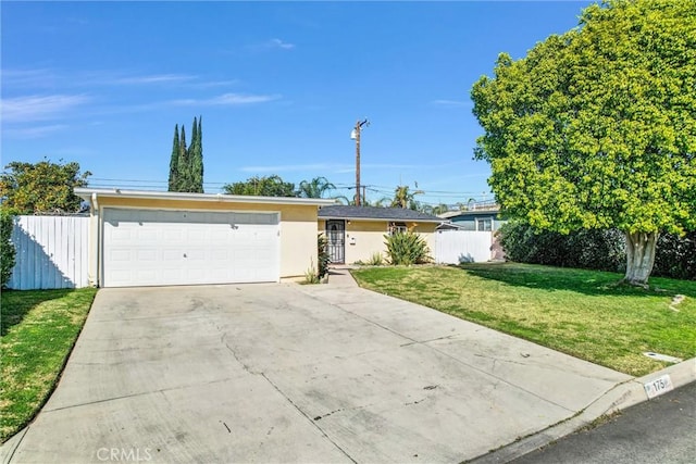 ranch-style house with a garage and a front yard