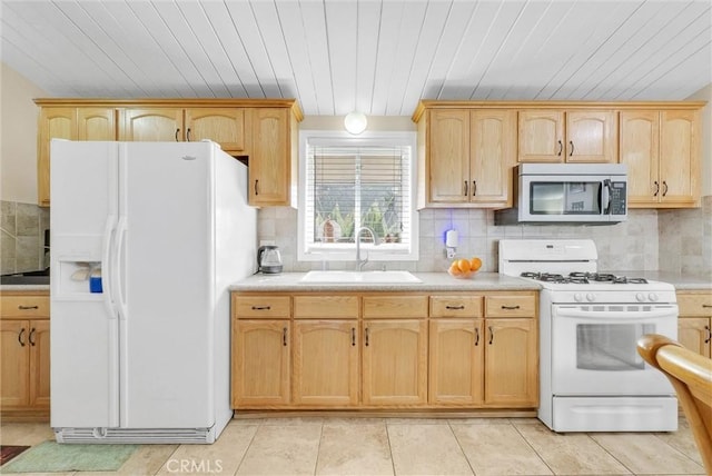 kitchen featuring sink, white appliances, backsplash, and light tile patterned floors