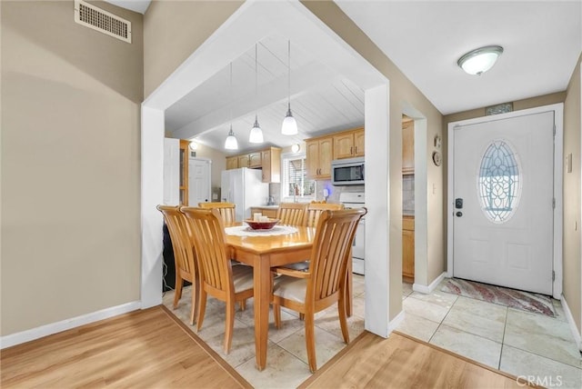 dining space with light hardwood / wood-style flooring