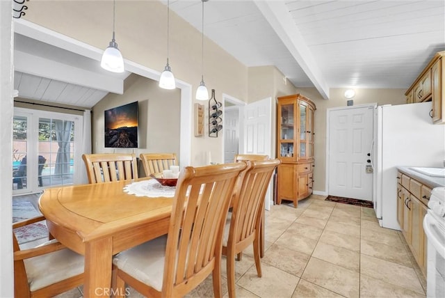 tiled dining space featuring lofted ceiling with beams