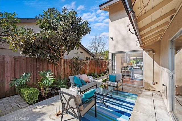 view of patio / terrace featuring fence and outdoor lounge area