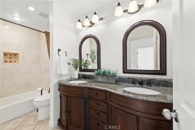 full bath featuring double vanity, visible vents, a sink, and tile patterned floors