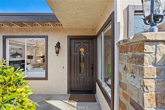 doorway to property with stucco siding