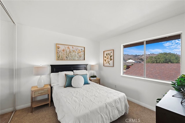 bedroom with carpet and baseboards