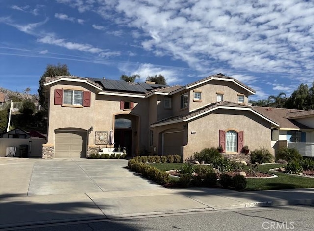 view of front of home with a garage and solar panels