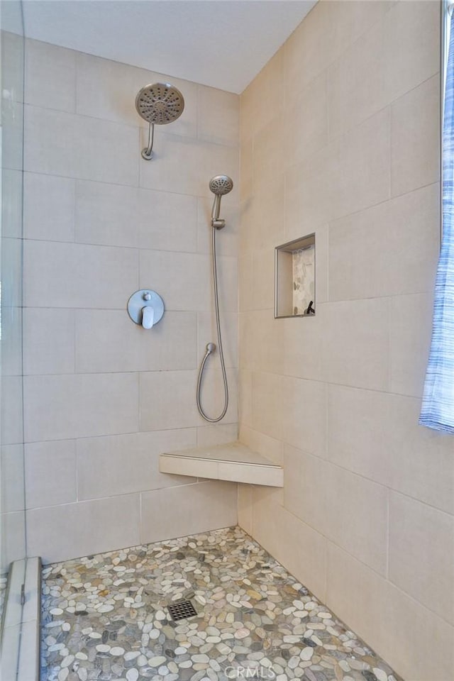 bathroom with tiled shower