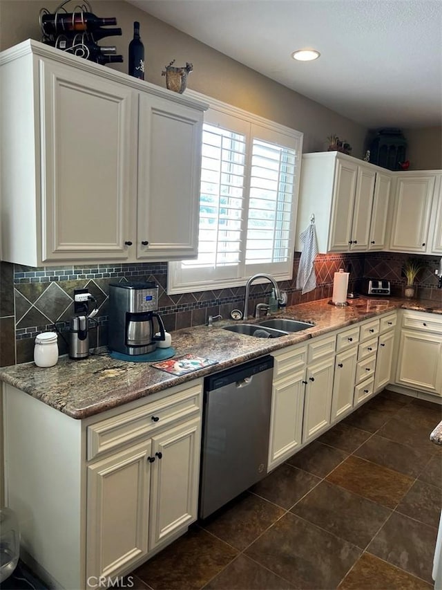 kitchen with sink, backsplash, light stone counters, white cabinetry, and dishwasher