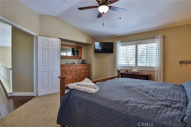 carpeted bedroom featuring ceiling fan and vaulted ceiling