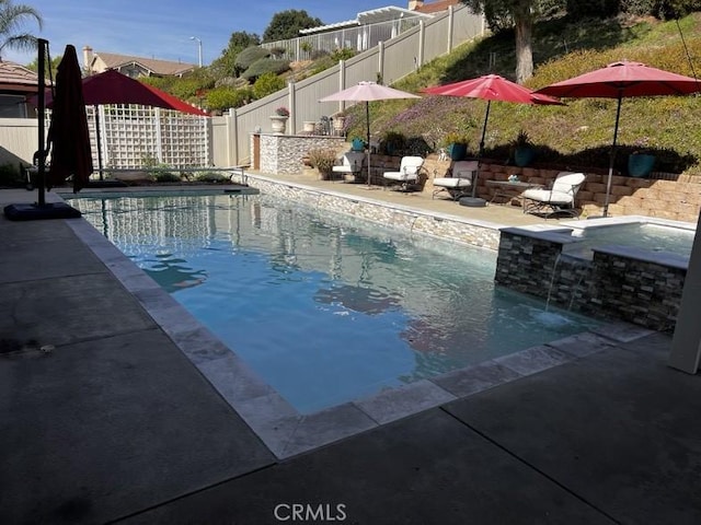 view of swimming pool with an in ground hot tub