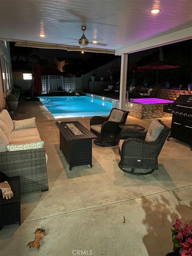 view of swimming pool featuring ceiling fan, a patio, outdoor lounge area, and a grill