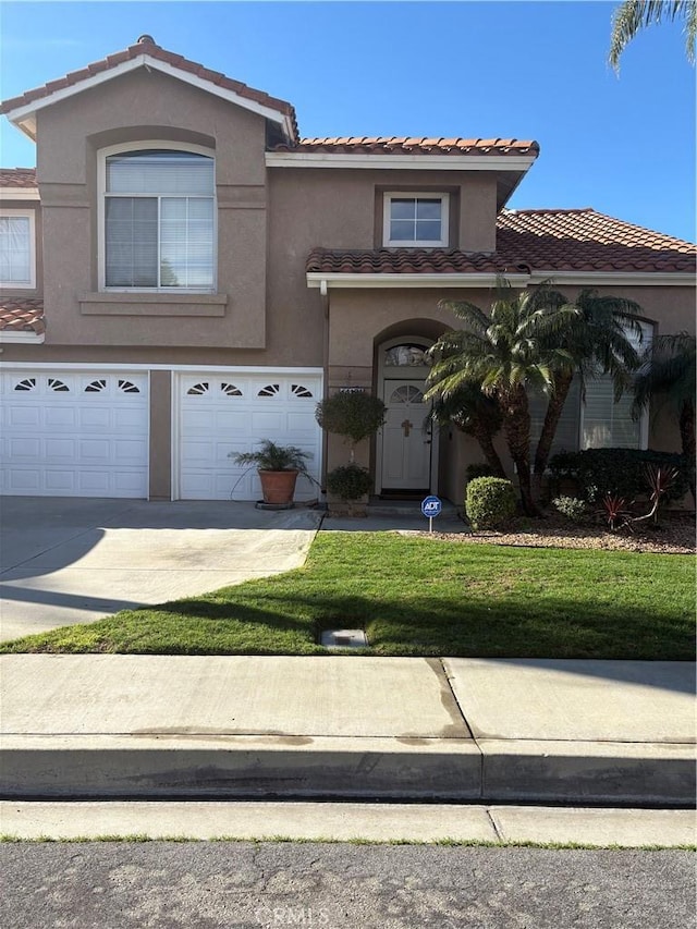 view of front of house with a front yard and a garage