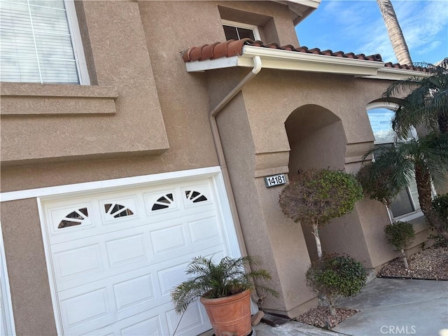 doorway to property with a garage