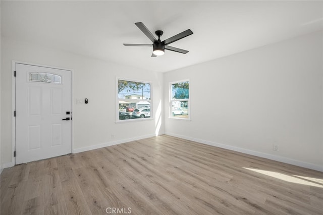 entryway featuring light wood-style flooring, baseboards, and ceiling fan