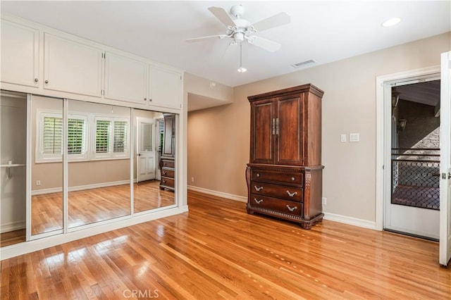 unfurnished bedroom with ceiling fan and light hardwood / wood-style flooring