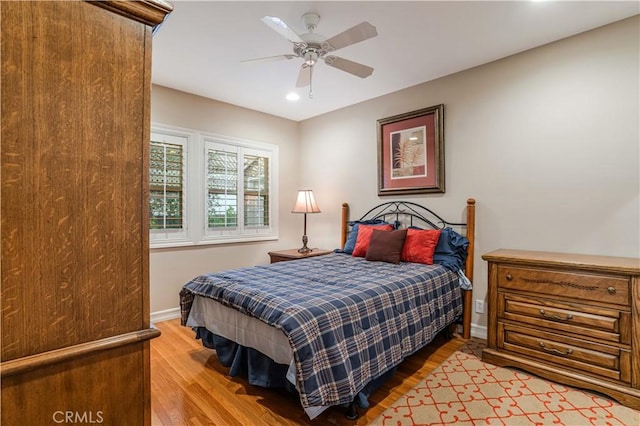 bedroom with light wood-type flooring and ceiling fan