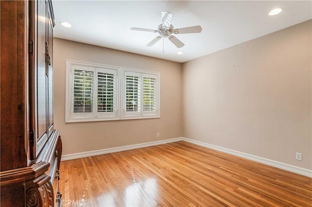 empty room with hardwood / wood-style floors and ceiling fan