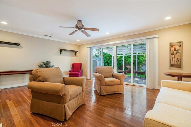 living room with ceiling fan, crown molding, and hardwood / wood-style floors