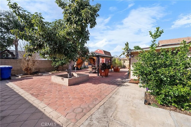 view of patio / terrace featuring a gazebo and a fenced backyard