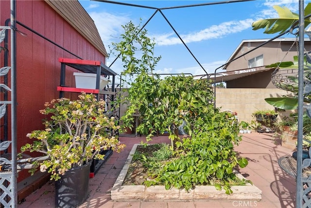 exterior space with a garden and fence