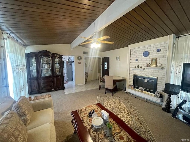 living room featuring lofted ceiling with beams, light colored carpet, a fireplace, wood ceiling, and a ceiling fan