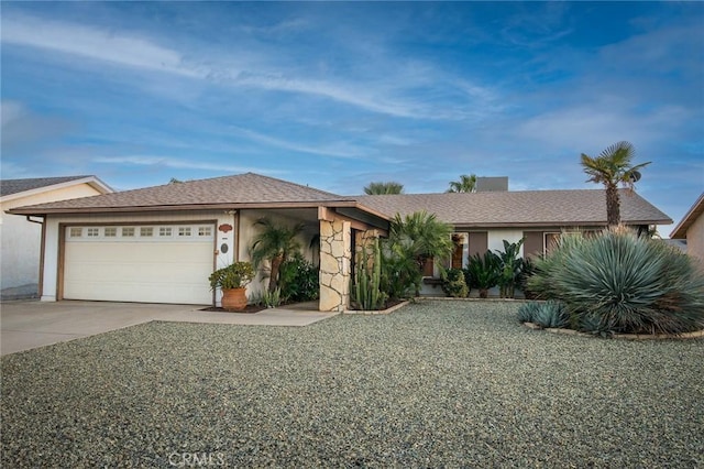 view of front facade featuring stucco siding, an attached garage, and driveway