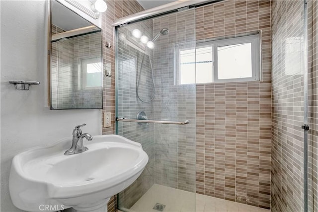 bathroom featuring a sink and a stall shower