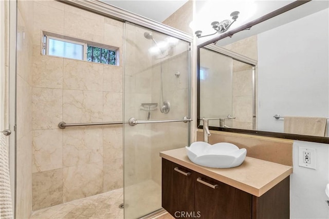 bathroom with a stall shower and vanity