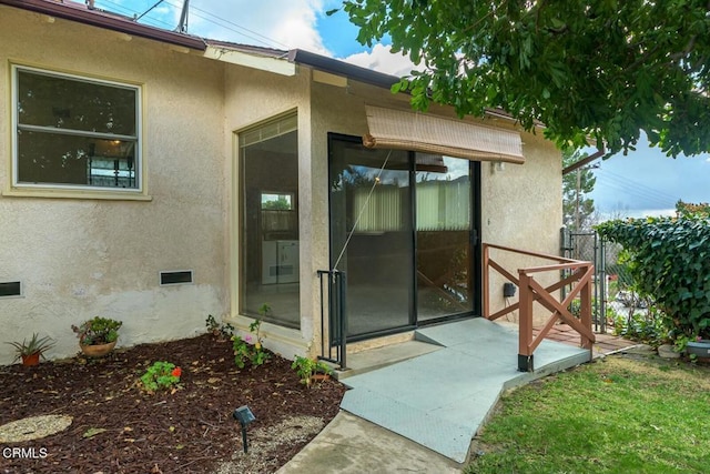 view of exterior entry featuring a patio area