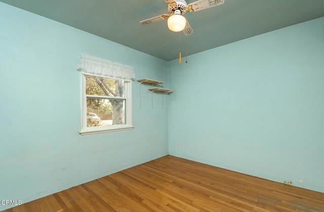 unfurnished room with ceiling fan and wood-type flooring