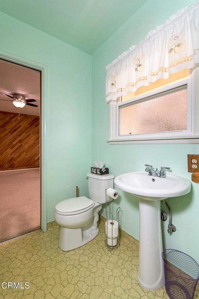 bathroom with ceiling fan, sink, and toilet