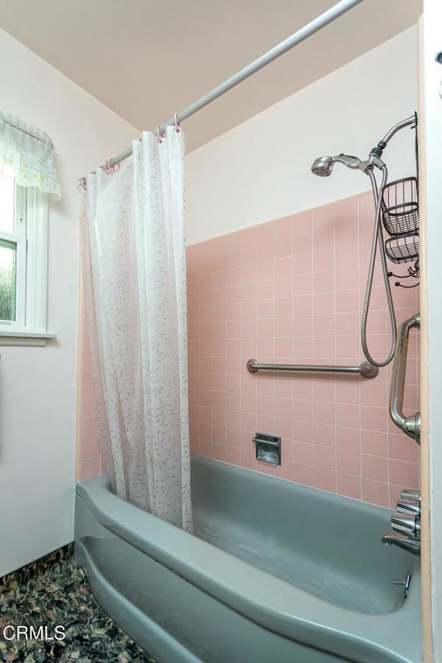 bathroom with shower / tub combo with curtain