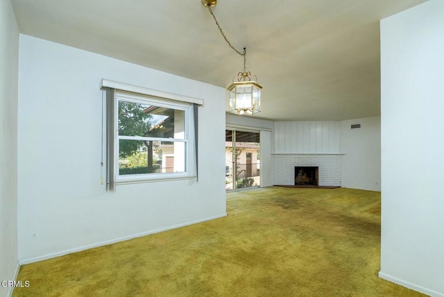 unfurnished living room with a fireplace and carpet