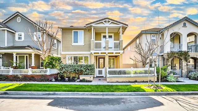 view of front of property with a fenced front yard and a balcony