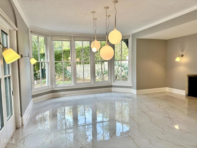 unfurnished dining area with marble finish floor, baseboards, and crown molding