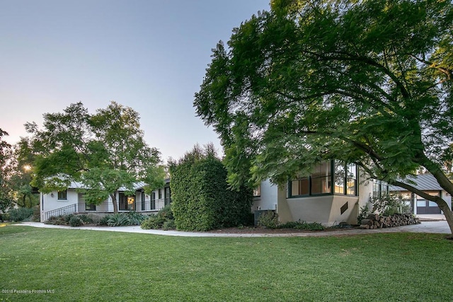 exterior space featuring stucco siding and a front yard