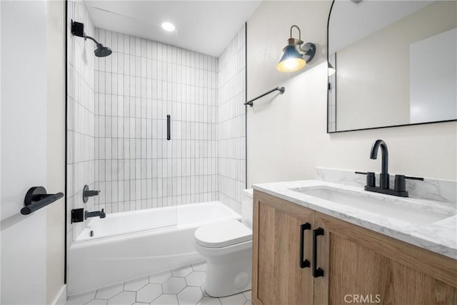 full bathroom featuring tile patterned flooring, toilet, vanity, and tiled shower / bath