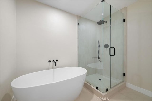 bathroom featuring shower with separate bathtub