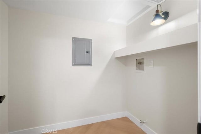 washroom featuring gas dryer hookup, electric panel, washer hookup, and wood-type flooring