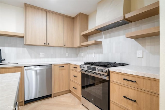 kitchen with light parquet flooring, stainless steel appliances, premium range hood, and light brown cabinets