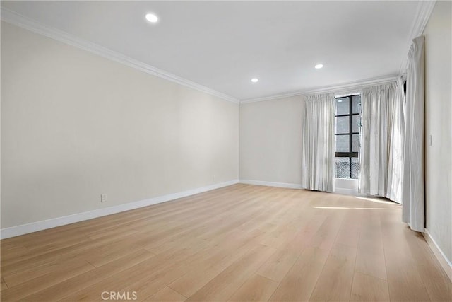 empty room with ornamental molding and light wood-type flooring