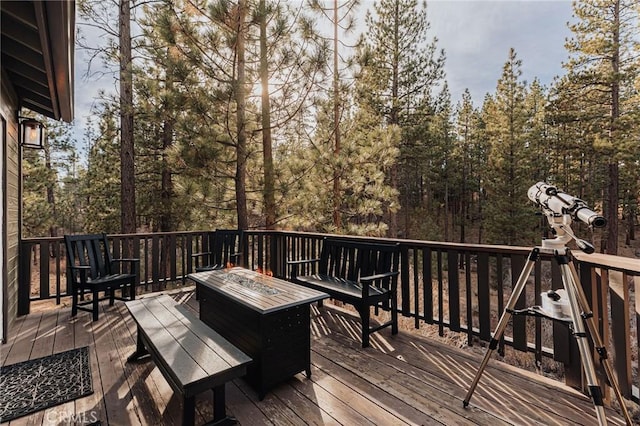 wooden terrace with a fire pit