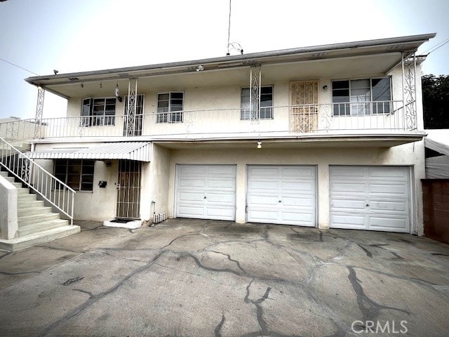 view of front of home featuring a garage and a balcony