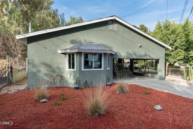 view of front of home with a carport