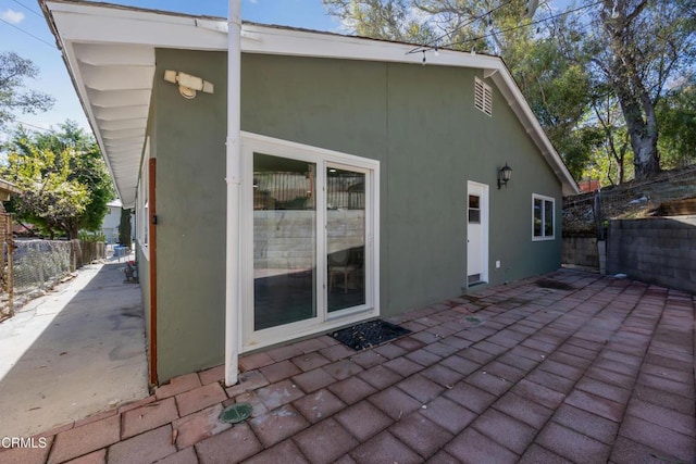 rear view of property featuring a patio area