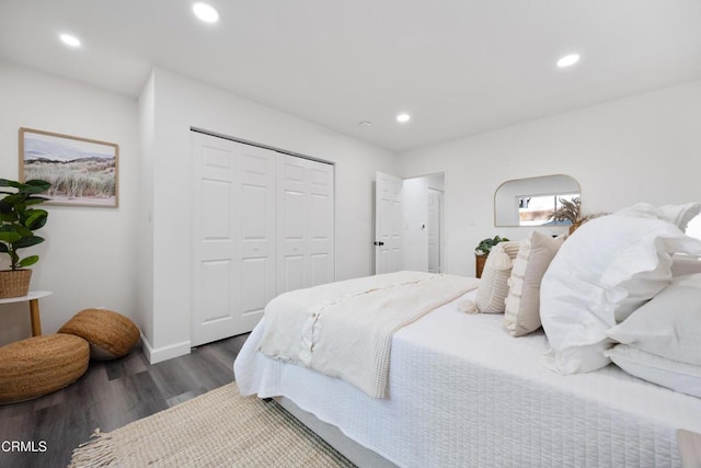 bedroom with a closet and dark hardwood / wood-style floors