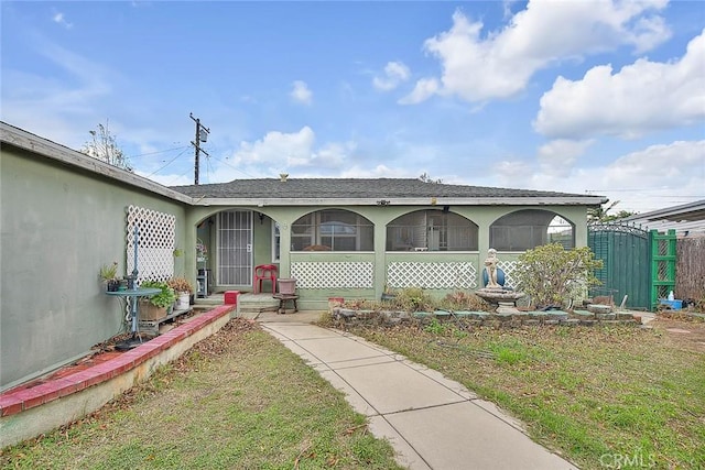 946 E J St, Ontario, CA 91764 - view of front of home with stucco siding, covered porch, a front yard, and fence