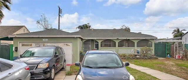 946 E J St, Ontario, CA 91764 - view of front facade featuring a gate, stucco siding, a shingled roof, and a garage