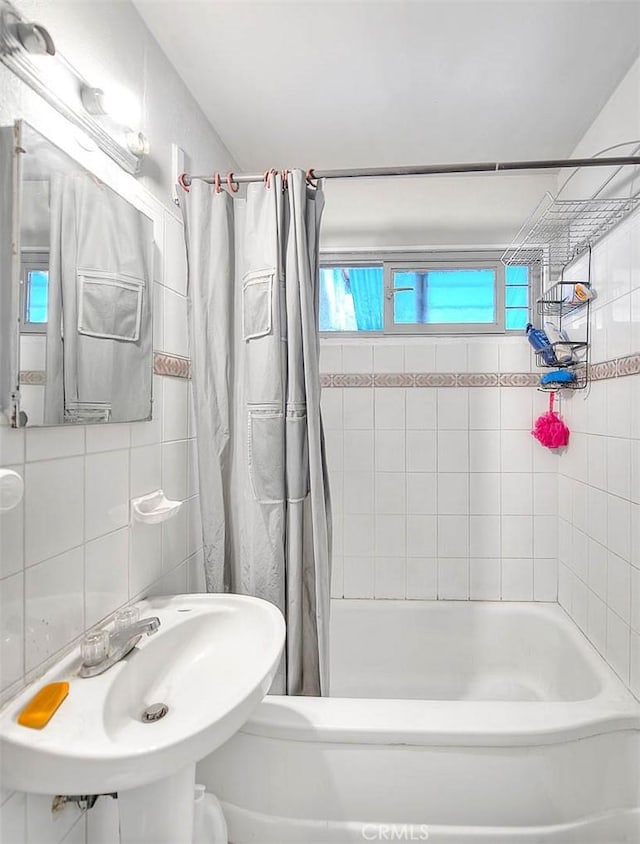 946 E J St, Ontario, CA 91764 - bathroom with shower / tub combo with curtain, a sink, and backsplash