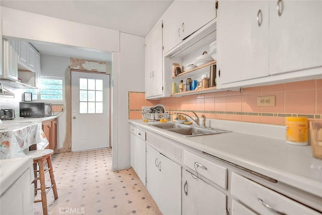 946 E J St, Ontario, CA 91764 - kitchen with open shelves, a sink, decorative backsplash, light floors, and light countertops